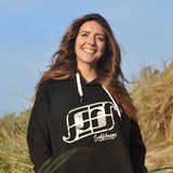 'Surf Kernow Logo' - Black organic cotton hoodie – Modelled by local surfer Dannie at Fistral beach in Newquay, Cornwall.